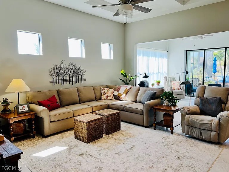 12804 Epping Way Fort Myers, FL 33913 - Photo 2 of 15 a living room with furniture a chandelier fan and a window