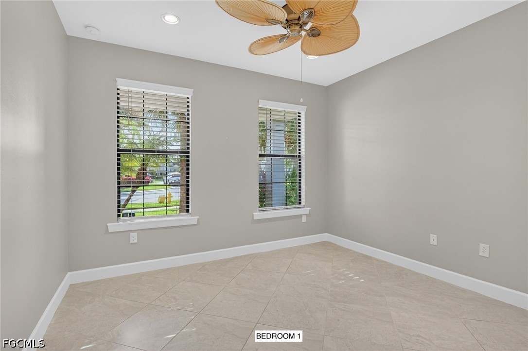 12804 Epping Way Fort Myers, FL 33913 - Photo 22 of 40 an empty room with windows and fan
