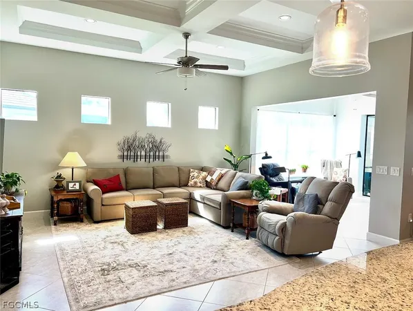 a living room with furniture and a chandelier