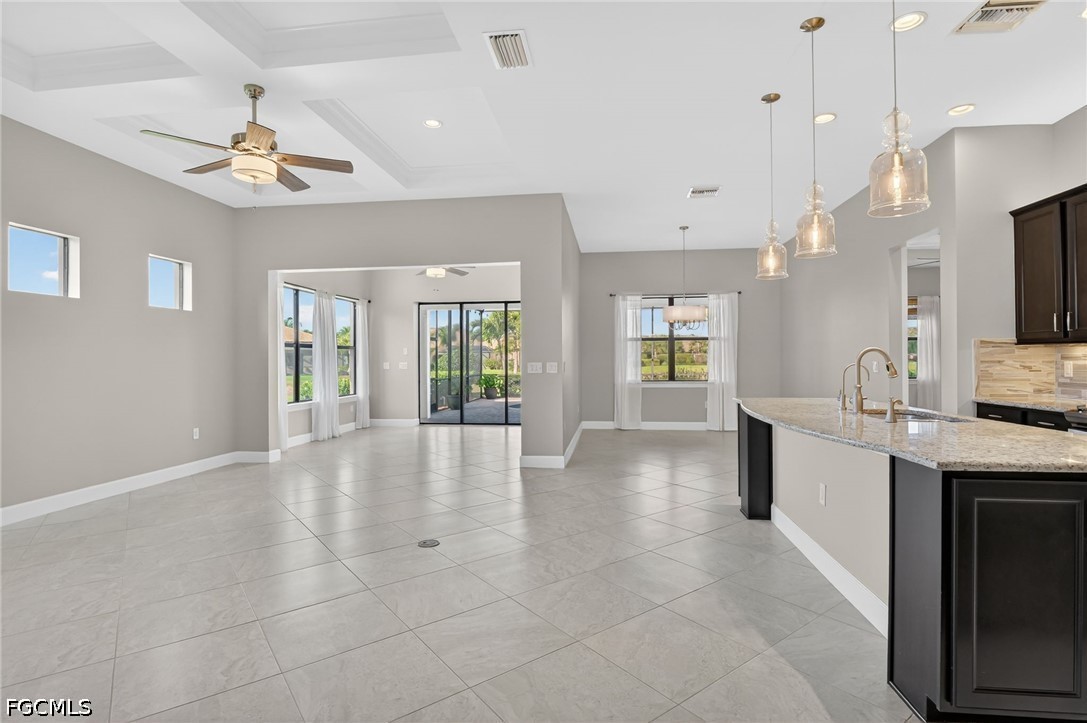 12804 Epping Way Fort Myers, FL 33913 - Photo 4 of 40 a large white kitchen with a large window cabinets and stainless steel appliances