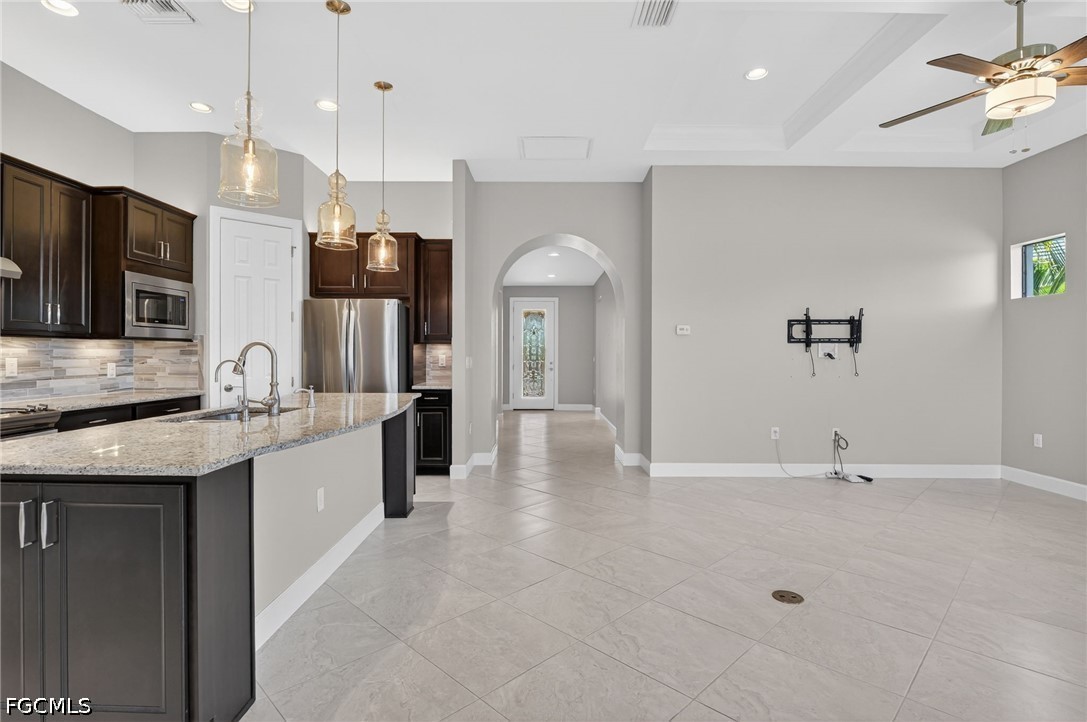 12804 Epping Way Fort Myers, FL 33913 - Photo 8 of 40 a large kitchen with kitchen island a sink stainless steel appliances and cabinets