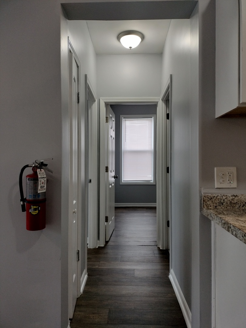 6601 South Green Street, Unit 8172 Chicago, IL 60621 - Photo 5 of 8 a view of a hallway with wooden floor