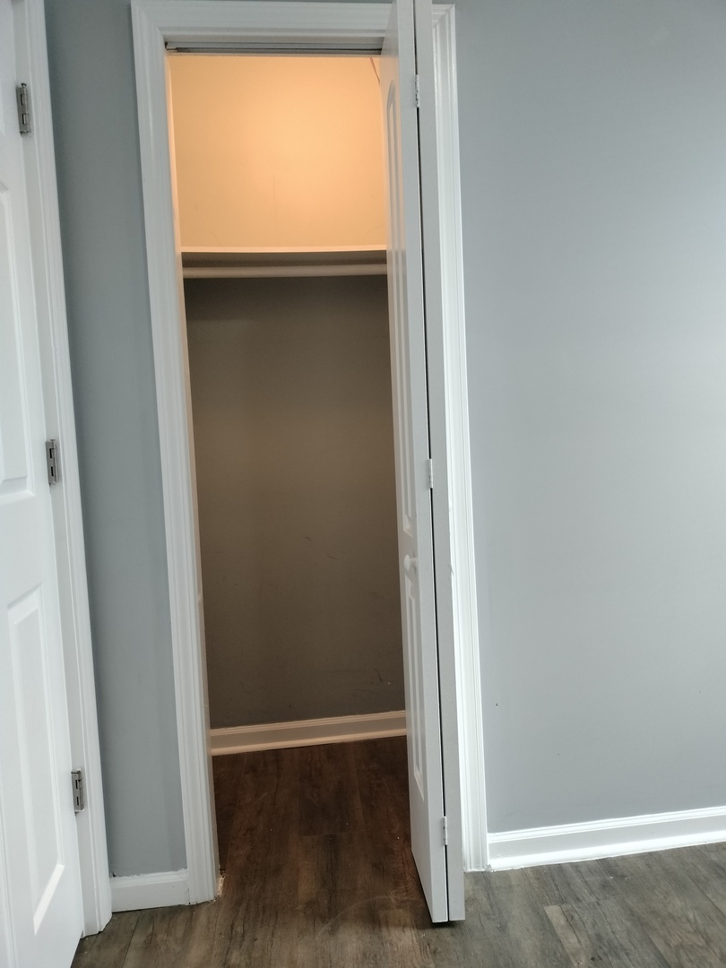 6601 South Green Street, Unit 8172 Chicago, IL 60621 - Photo 7 of 8 an empty room with wooden floor and entrance