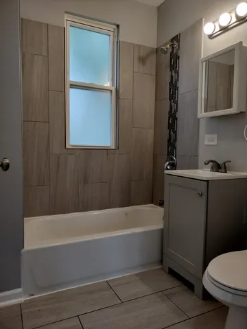 a bathroom with a toilet a sink and bathtub