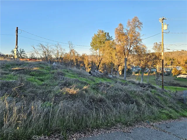 a view of a house with a yard and mountain