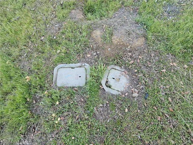 an aerial view of a house with a yard and trees in the back