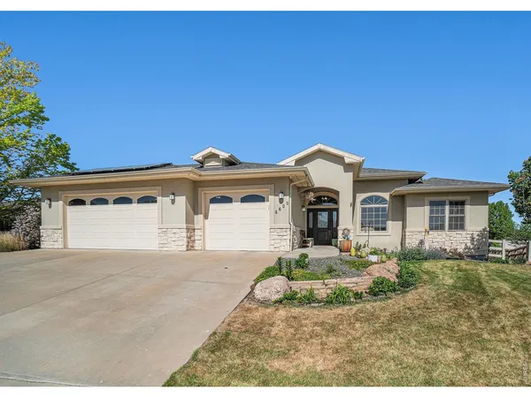 a front view of a house with a yard and garage