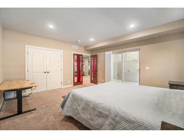 a bedroom with a bed and a night stand