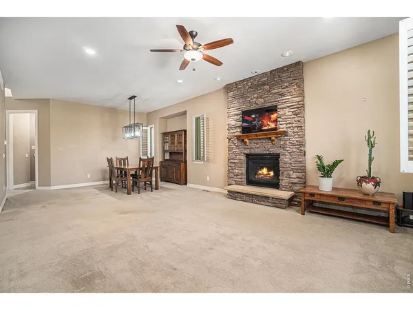 a view of a livingroom with furniture and a ceiling fan