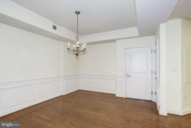 a view of a chandelier fan and entryway
