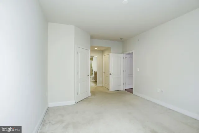 a bathroom with a granite countertop sink a toilet a mirror and shower