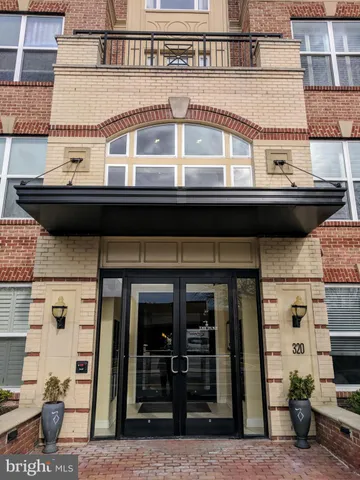 a view of a brick building next to a yard