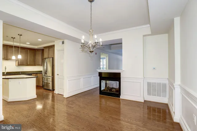 a view of a kitchen with a sink and a refrigerator