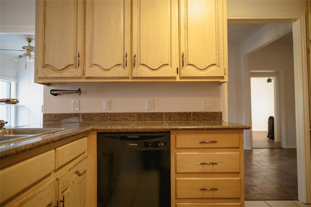 9029 Church Road Dallas, TX 75231 - Photo 12 of 40 a kitchen with granite countertop a sink and cabinets