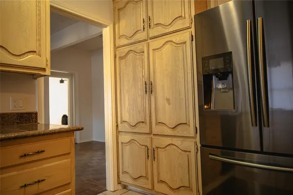 a kitchen with granite countertop white cabinets and stainless steel appliances