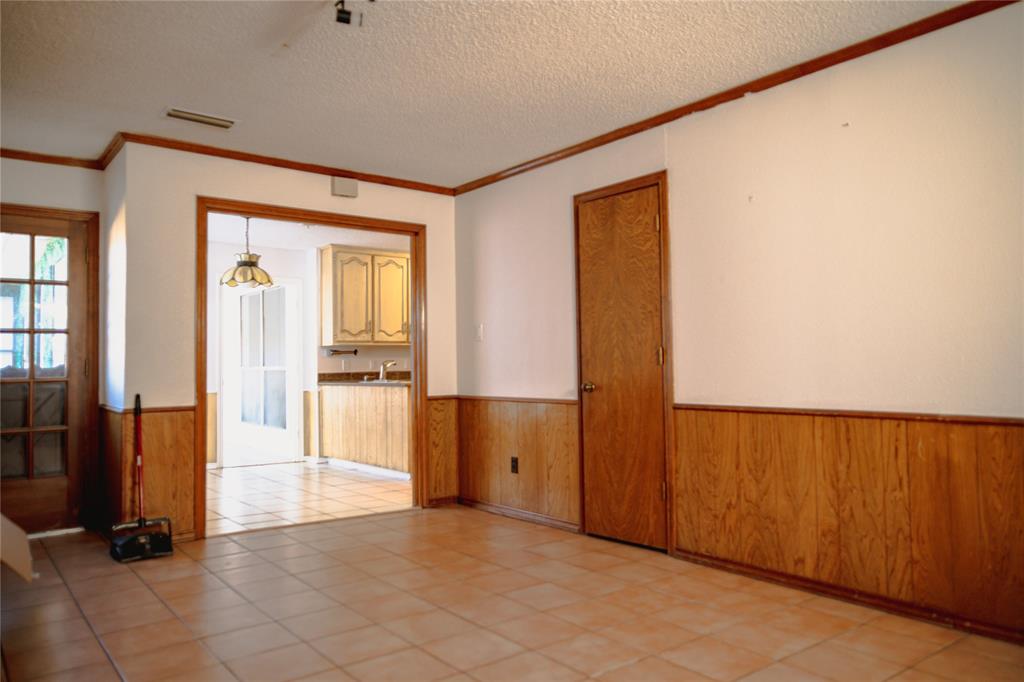 9029 Church Road Dallas, TX 75231 - Photo 19 of 40 a view of a hallway with wooden floor and a cabinet