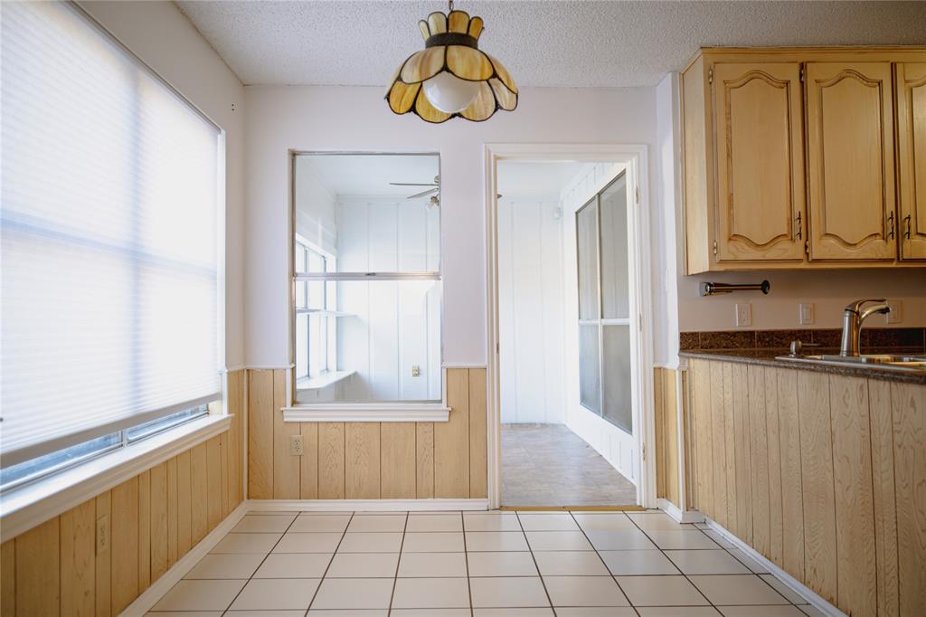 9029 Church Road Dallas, TX 75231 - Photo 20 of 40 a view of a refrigerator in kitchen and entryway with wooden floor