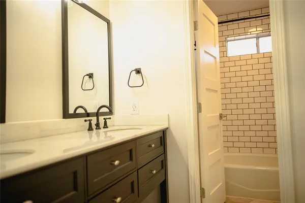 a bathroom with a double vanity sink and a mirror