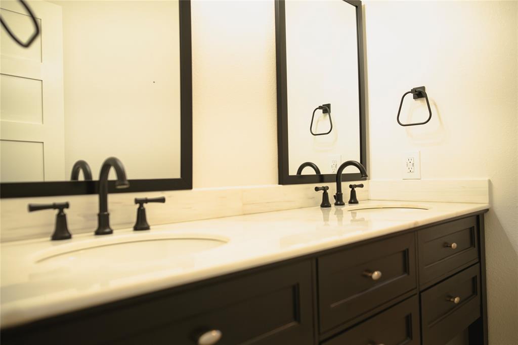 9029 Church Road Dallas, TX 75231 - Photo 26 of 40 a bathroom with a double vanity sink and a mirror