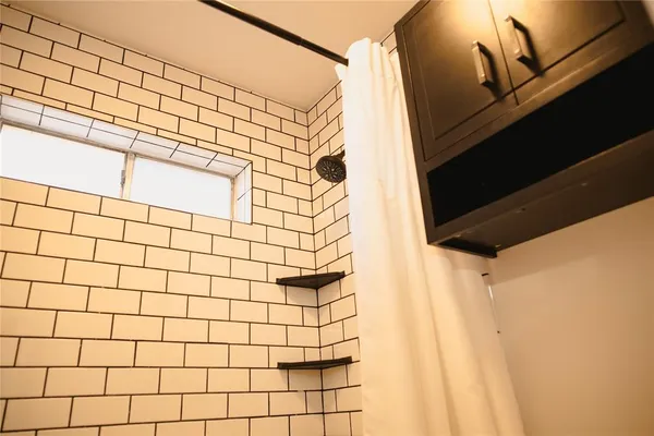 a bathroom with a double vanity sink and a mirror