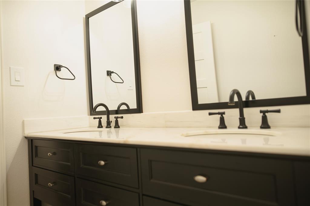 9029 Church Road Dallas, TX 75231 - Photo 28 of 40 a bathroom with a double vanity sink and a mirror