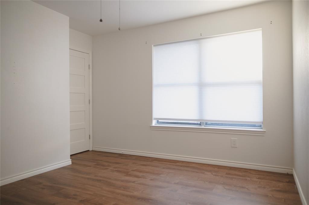 9029 Church Road Dallas, TX 75231 - Photo 33 of 40 an empty room with wooden floor and windows