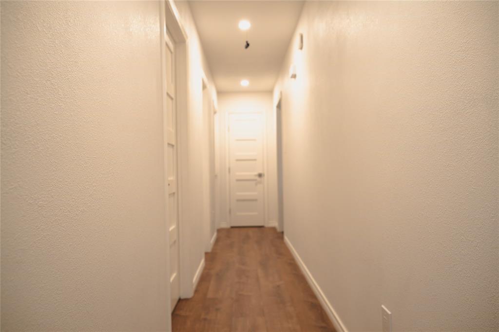 9029 Church Road Dallas, TX 75231 - Photo 35 of 40 a view of a hallway with wooden floor