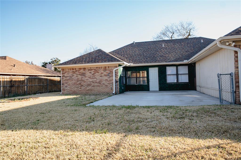 9029 Church Road Dallas, TX 75231 - Photo 39 of 40 a front view of a house with a yard and garage