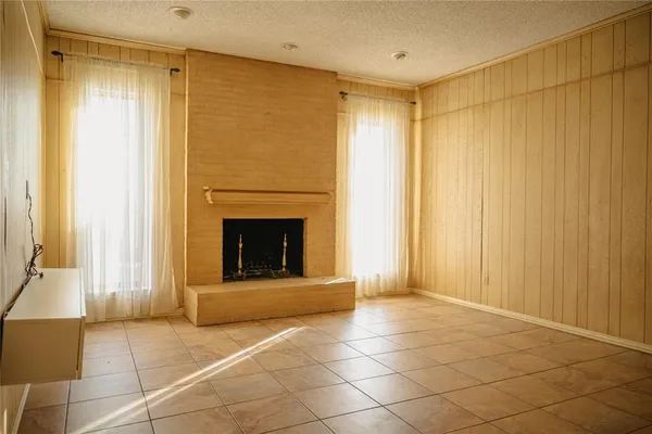 a view of an empty room with a fireplace