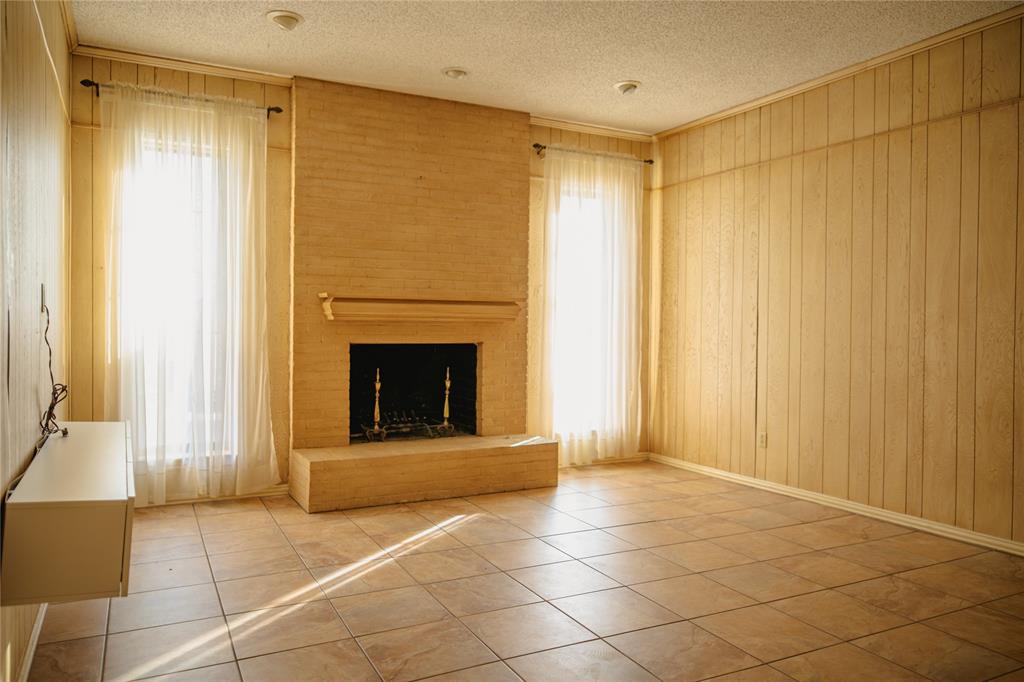 9029 Church Road Dallas, TX 75231 - Photo 6 of 40 a view of an empty room with a fireplace