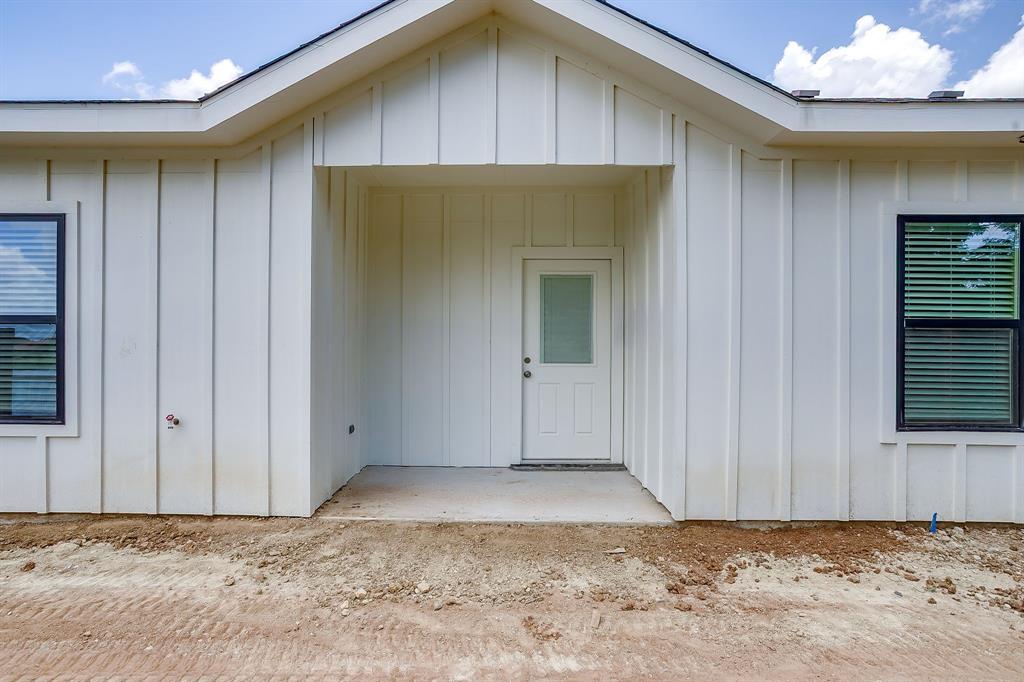 133 Winners Circle, Unit 302 Weatherford, TX 76087 - Photo 19 of 20 Entrance to property featuring board and batten siding