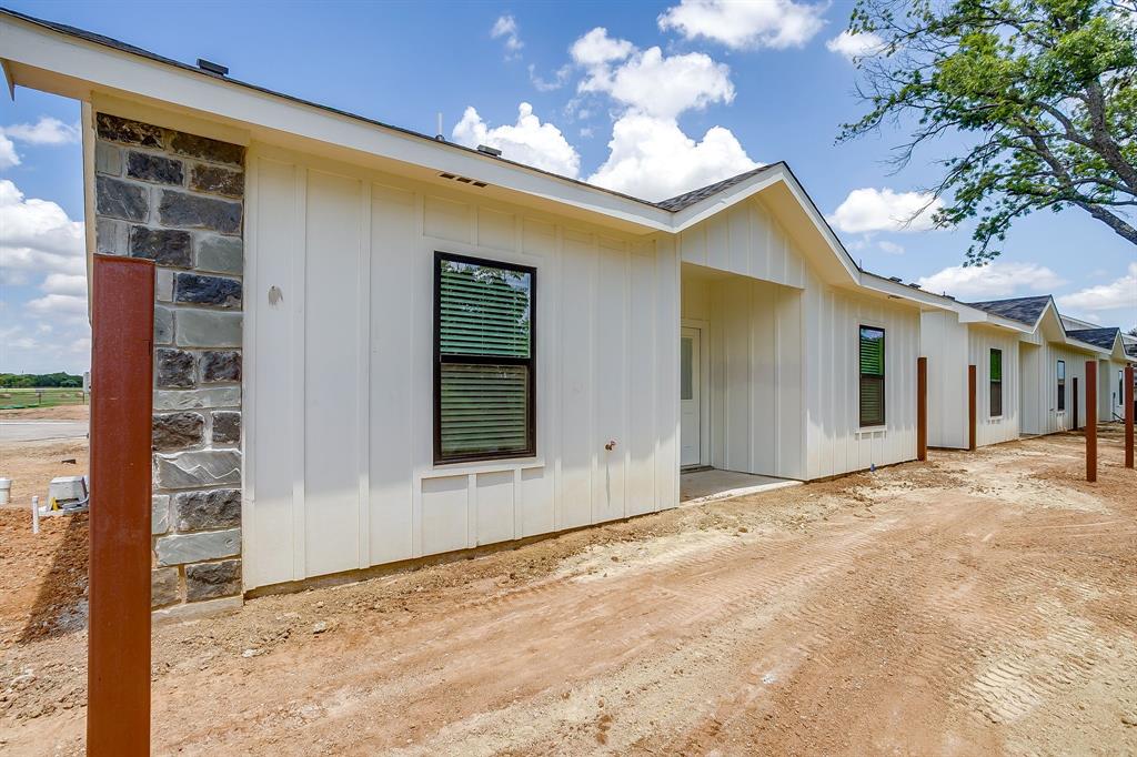 133 Winners Circle, Unit 302 Weatherford, TX 76087 - Photo 20 of 20 View of property exterior featuring board and batten siding