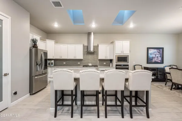a large kitchen with a table and chairs