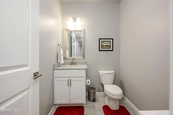 a bathroom with a toilet a sink and a mirror