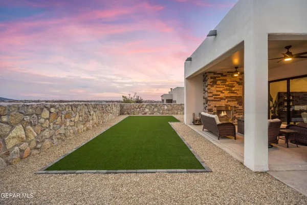 a backyard of a house with barbeque oven