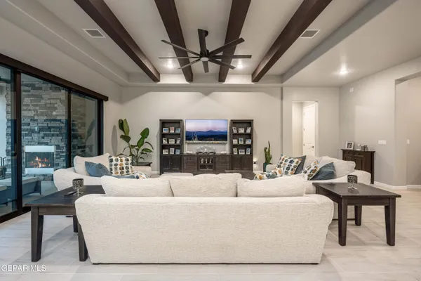 a living room with furniture and a chandelier