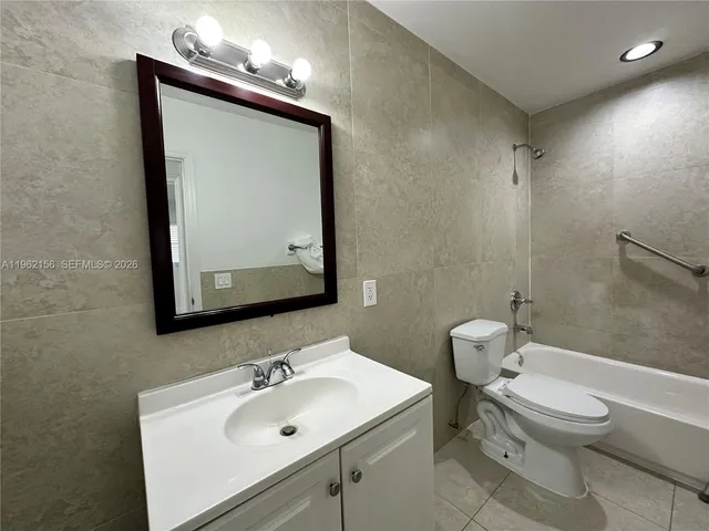 a bathroom with a toilet and a bath tub