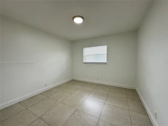 a view of swimming pool with lawn chairs and iron fence