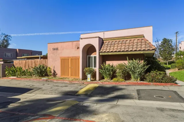 an aerial view of residential building with parking and mountain view