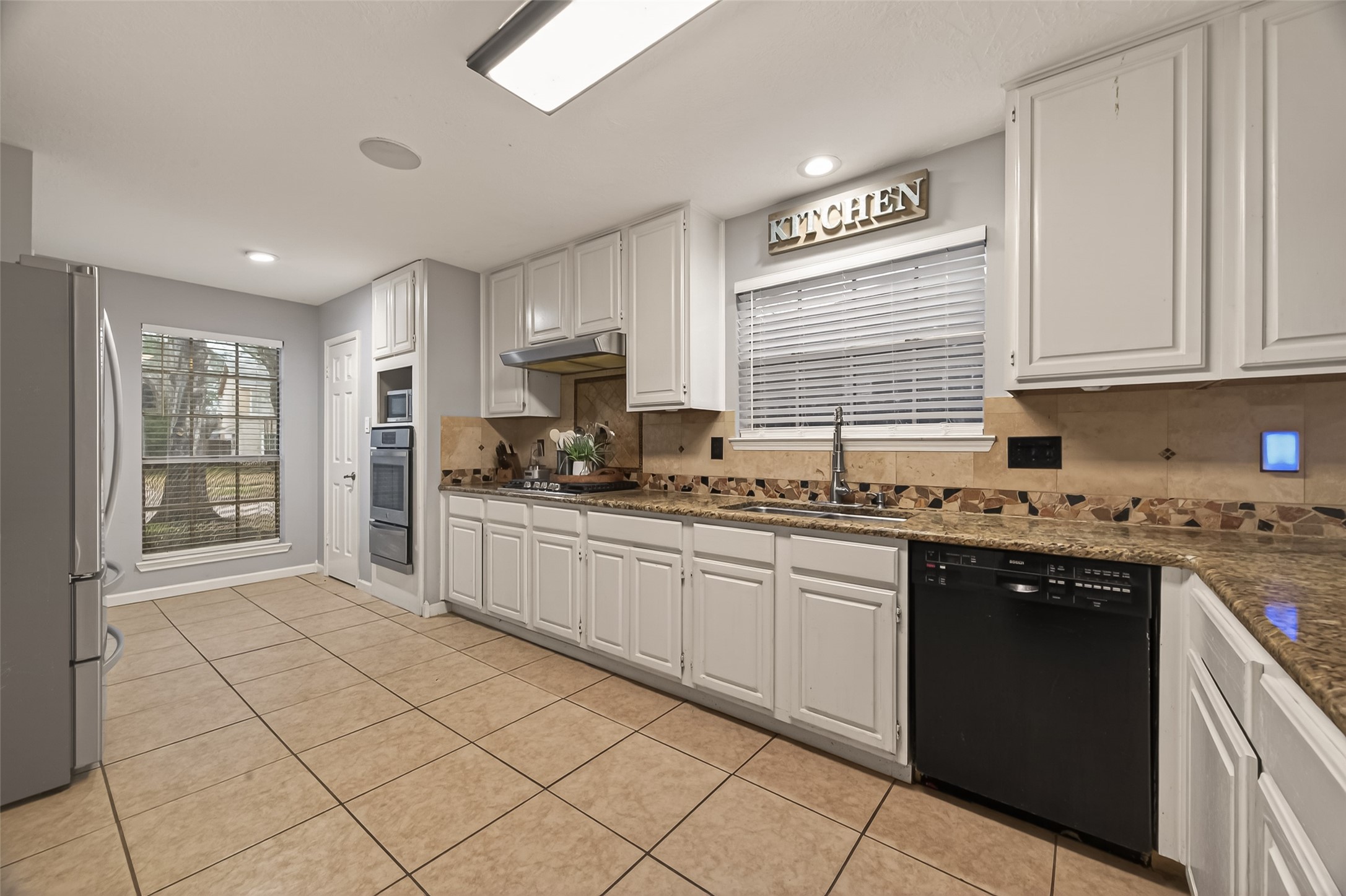 12206 Paddock Way Houston, TX 77065 - Photo 12 of 44 a kitchen with stainless steel appliances granite countertop a stove sink and cabinets