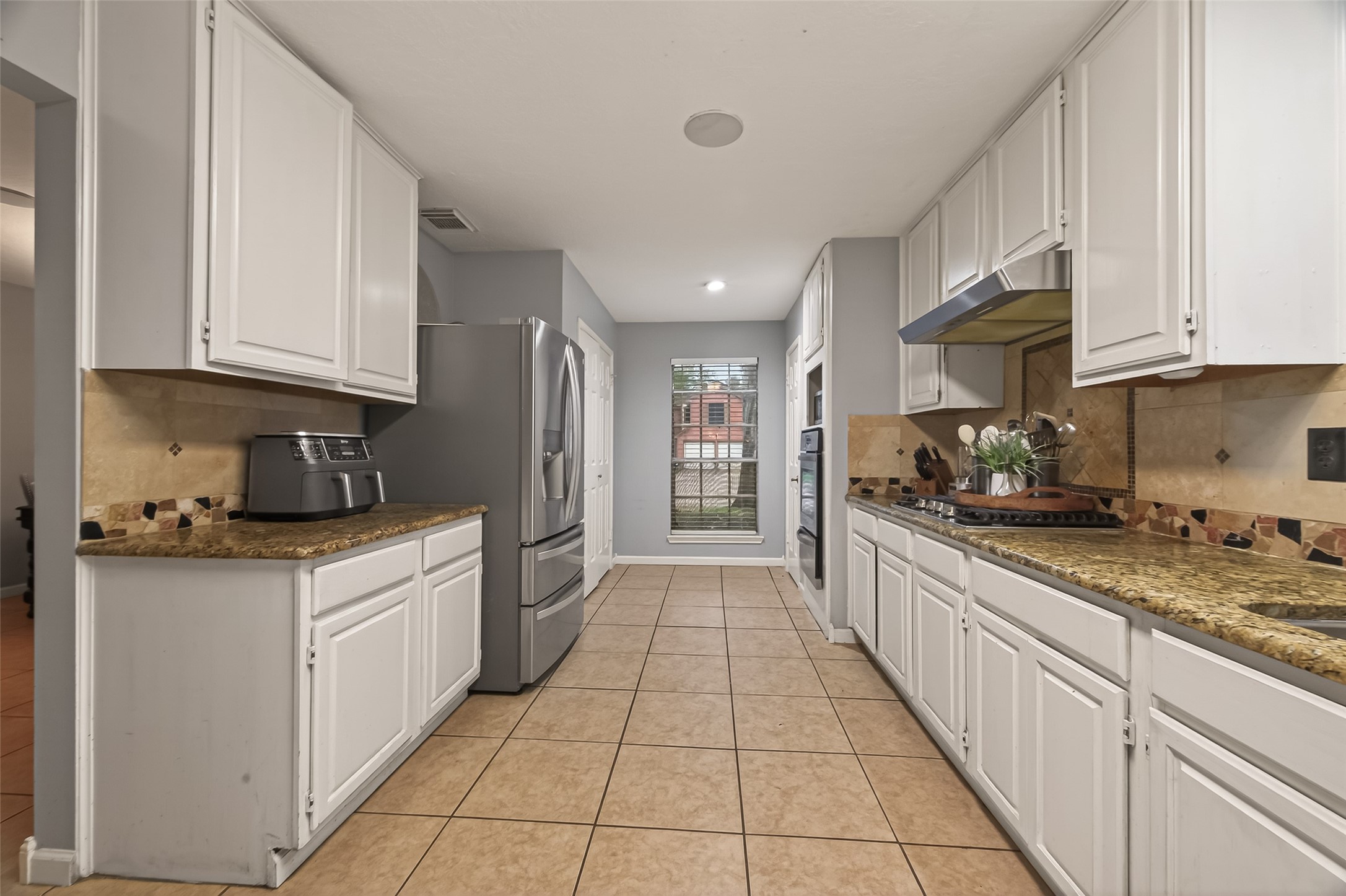12206 Paddock Way Houston, TX 77065 - Photo 13 of 44 a kitchen with stainless steel appliances granite countertop a refrigerator sink and cabinets