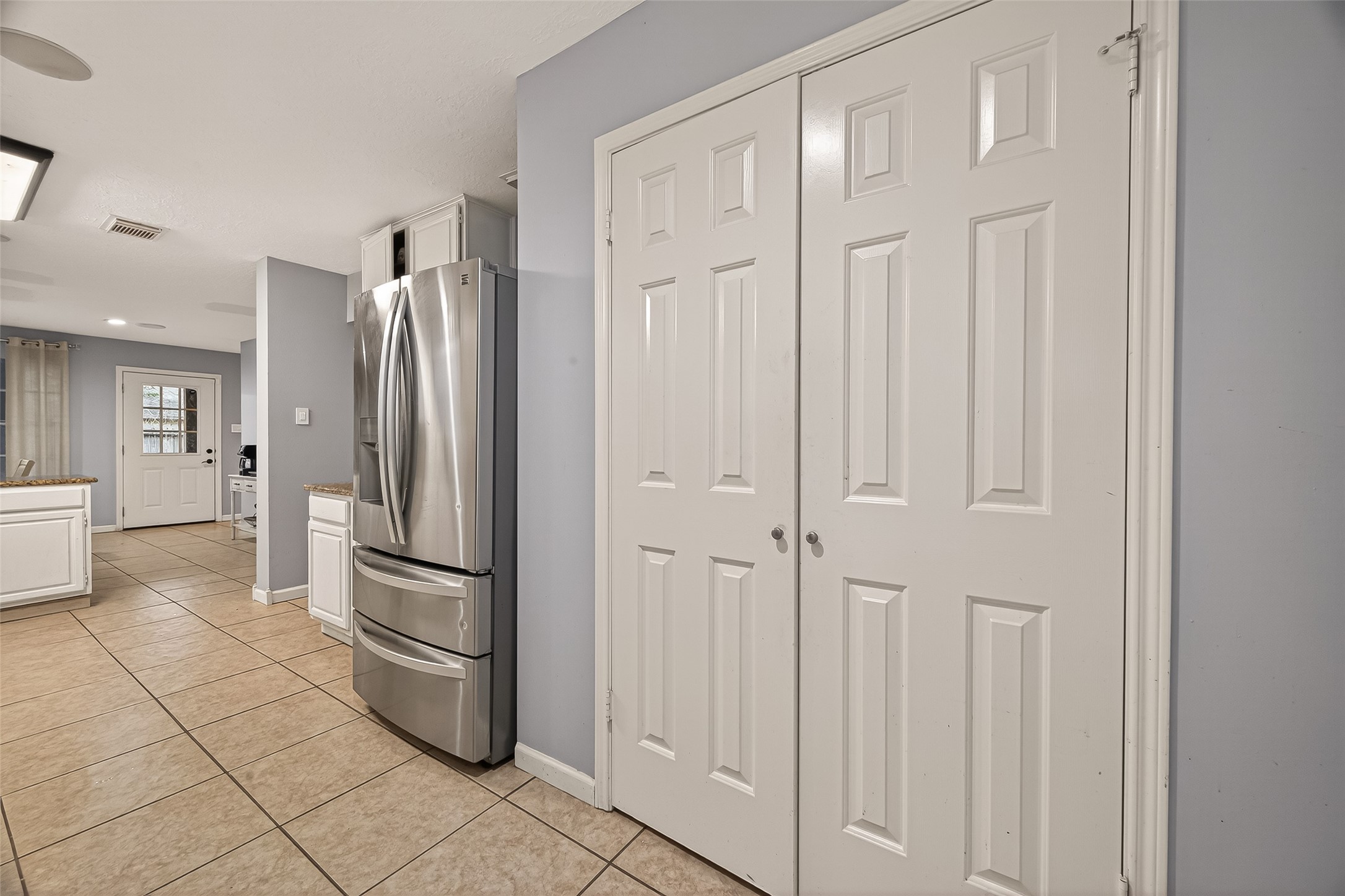 12206 Paddock Way Houston, TX 77065 - Photo 14 of 44 a kitchen with stainless steel appliances a refrigerator and cabinets