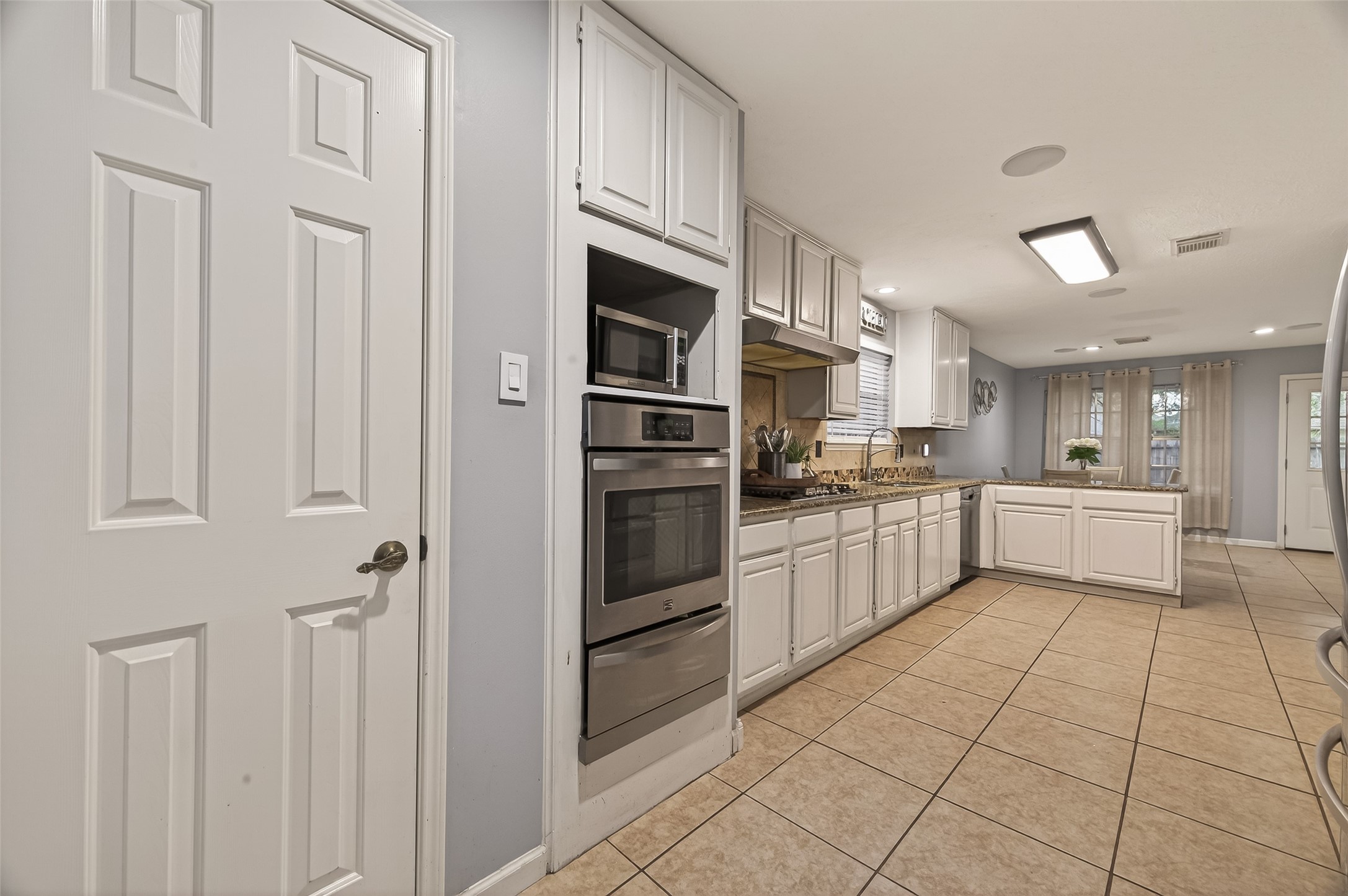 12206 Paddock Way Houston, TX 77065 - Photo 15 of 44 a kitchen with white cabinets and white appliances