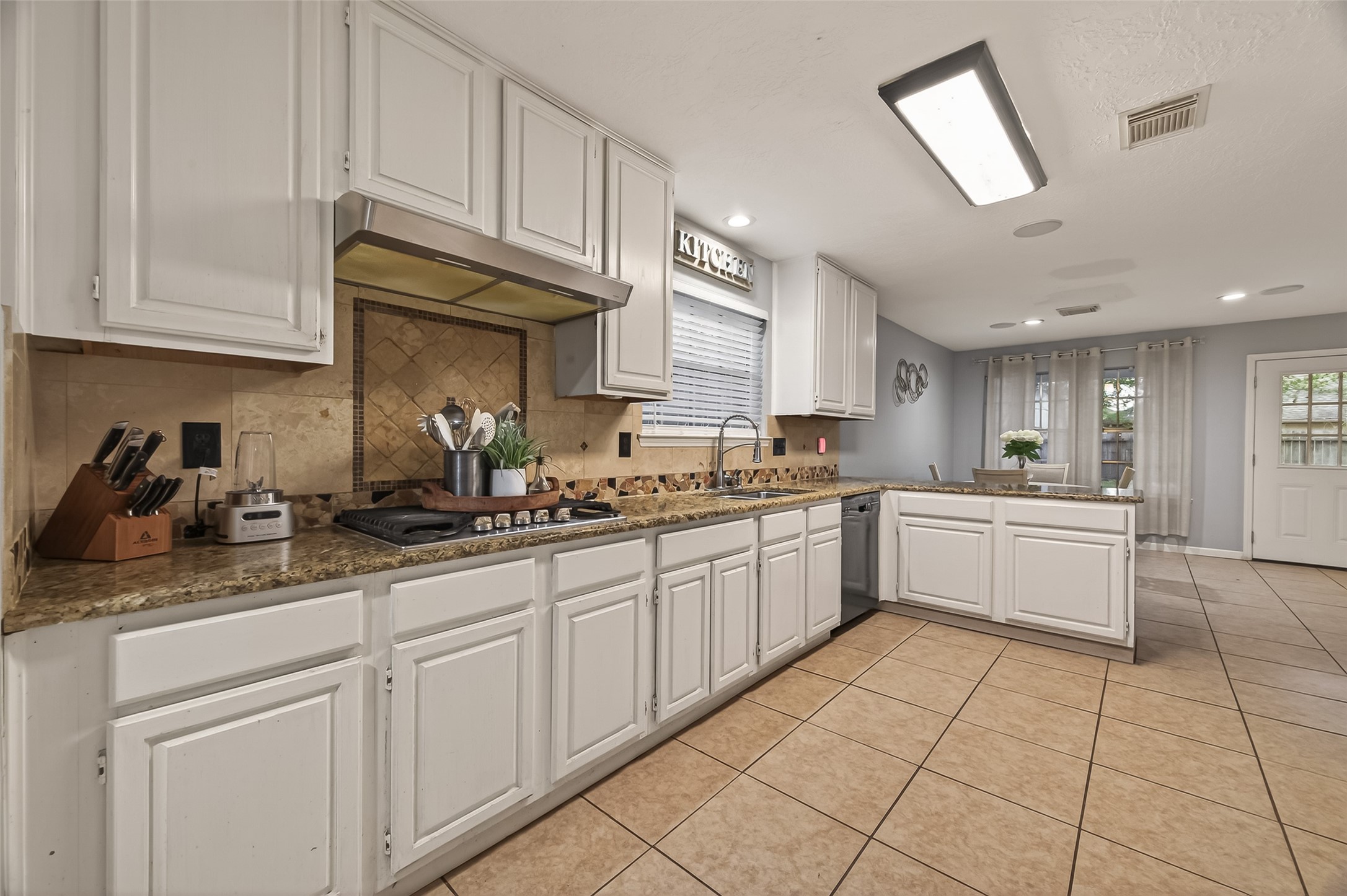 12206 Paddock Way Houston, TX 77065 - Photo 16 of 44 a kitchen with cabinets and window
