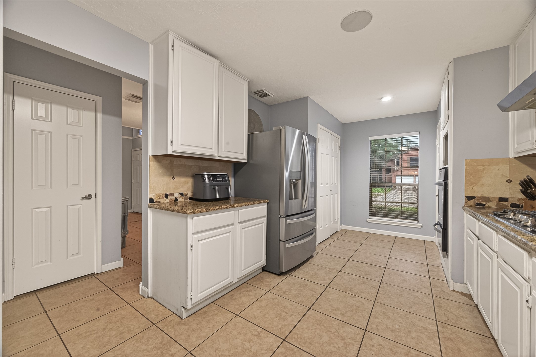12206 Paddock Way Houston, TX 77065 - Photo 17 of 44 a kitchen with stainless steel appliances granite countertop a refrigerator oven a sink and dishwasher