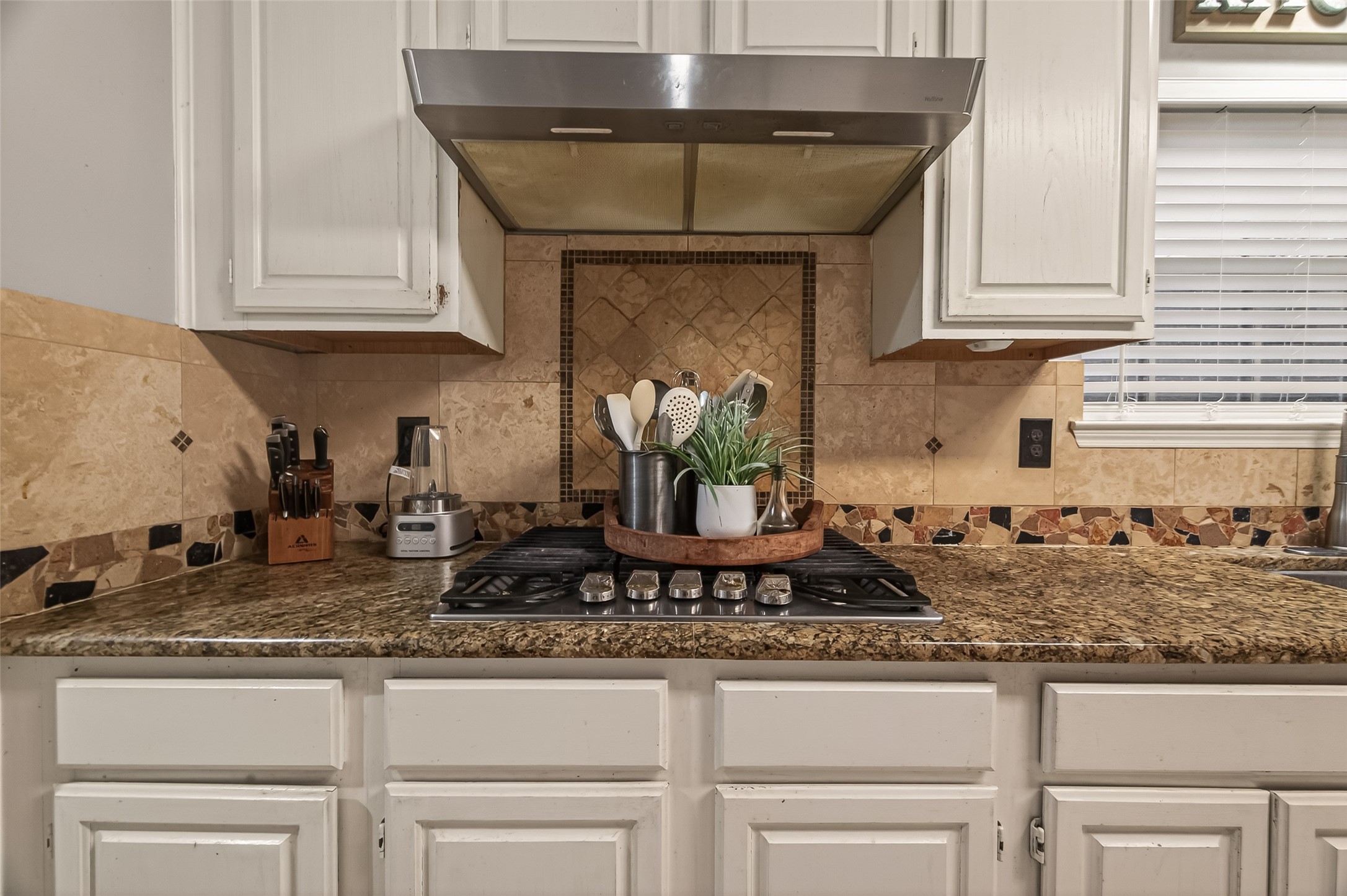 12206 Paddock Way Houston, TX 77065 - Photo 18 of 44 a kitchen with granite countertop a stove a sink and a granite counter tops