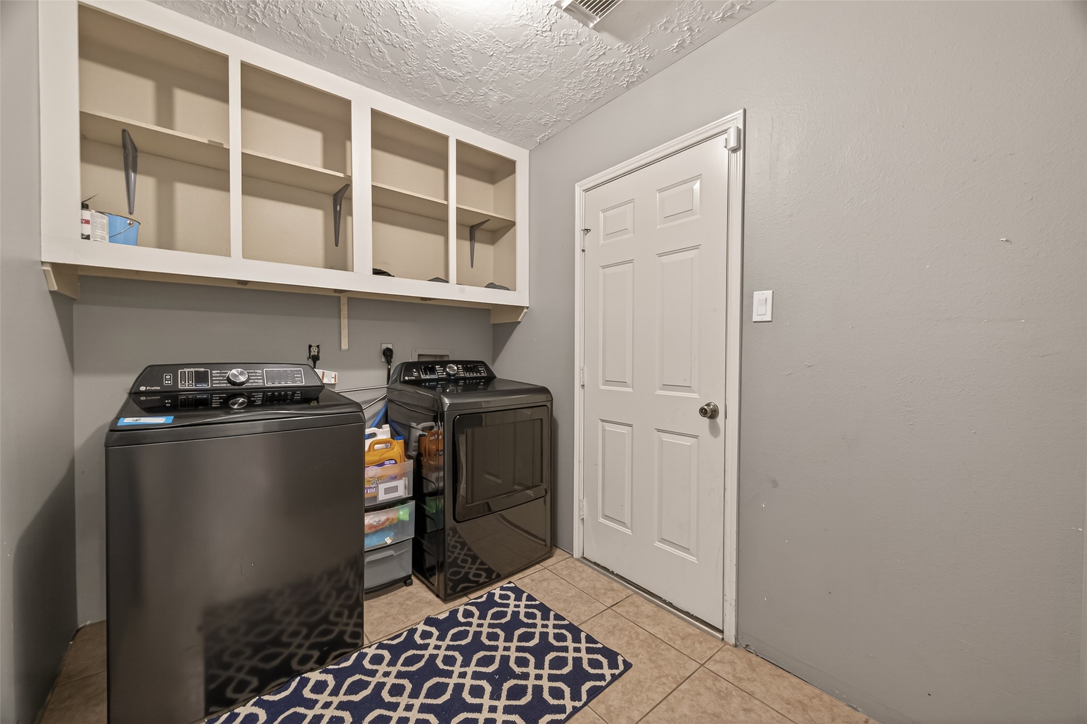 12206 Paddock Way Houston, TX 77065 - Photo 19 of 44 a view of a storage & utility room