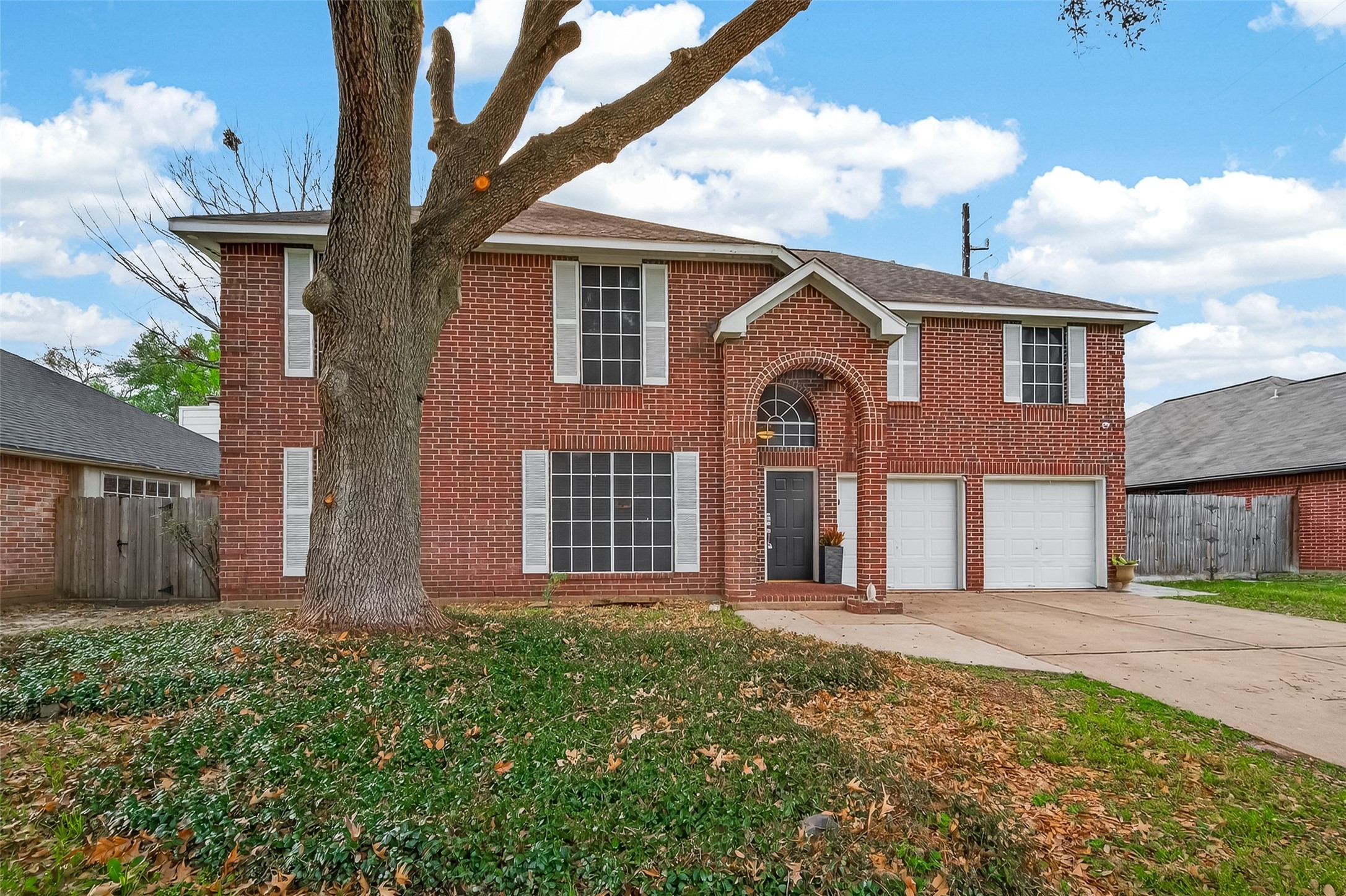 12206 Paddock Way Houston, TX 77065 - Photo 2 of 44 a front view of a house with a garden