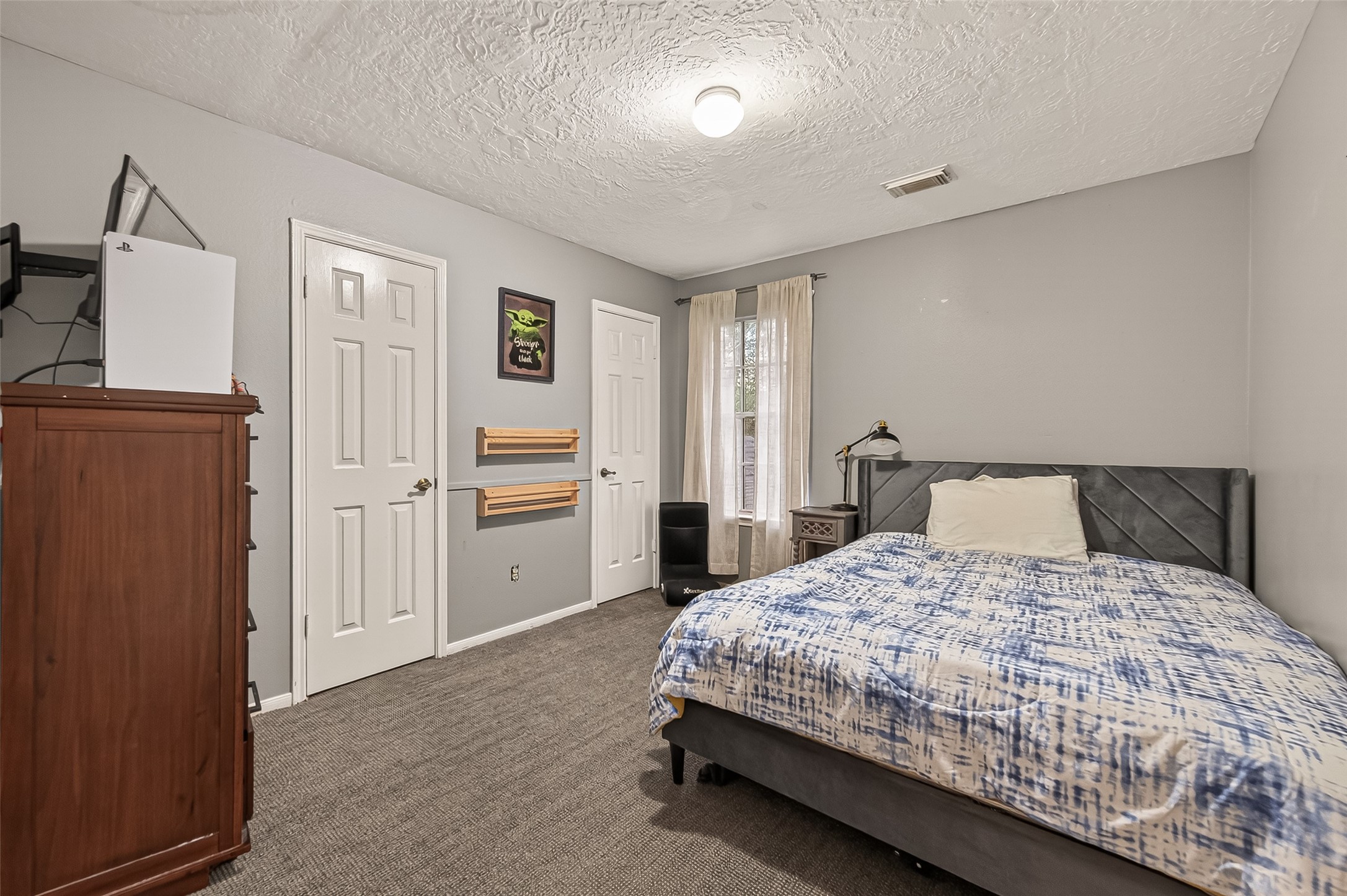 12206 Paddock Way Houston, TX 77065 - Photo 23 of 44 a bedroom with a bed and cabinets