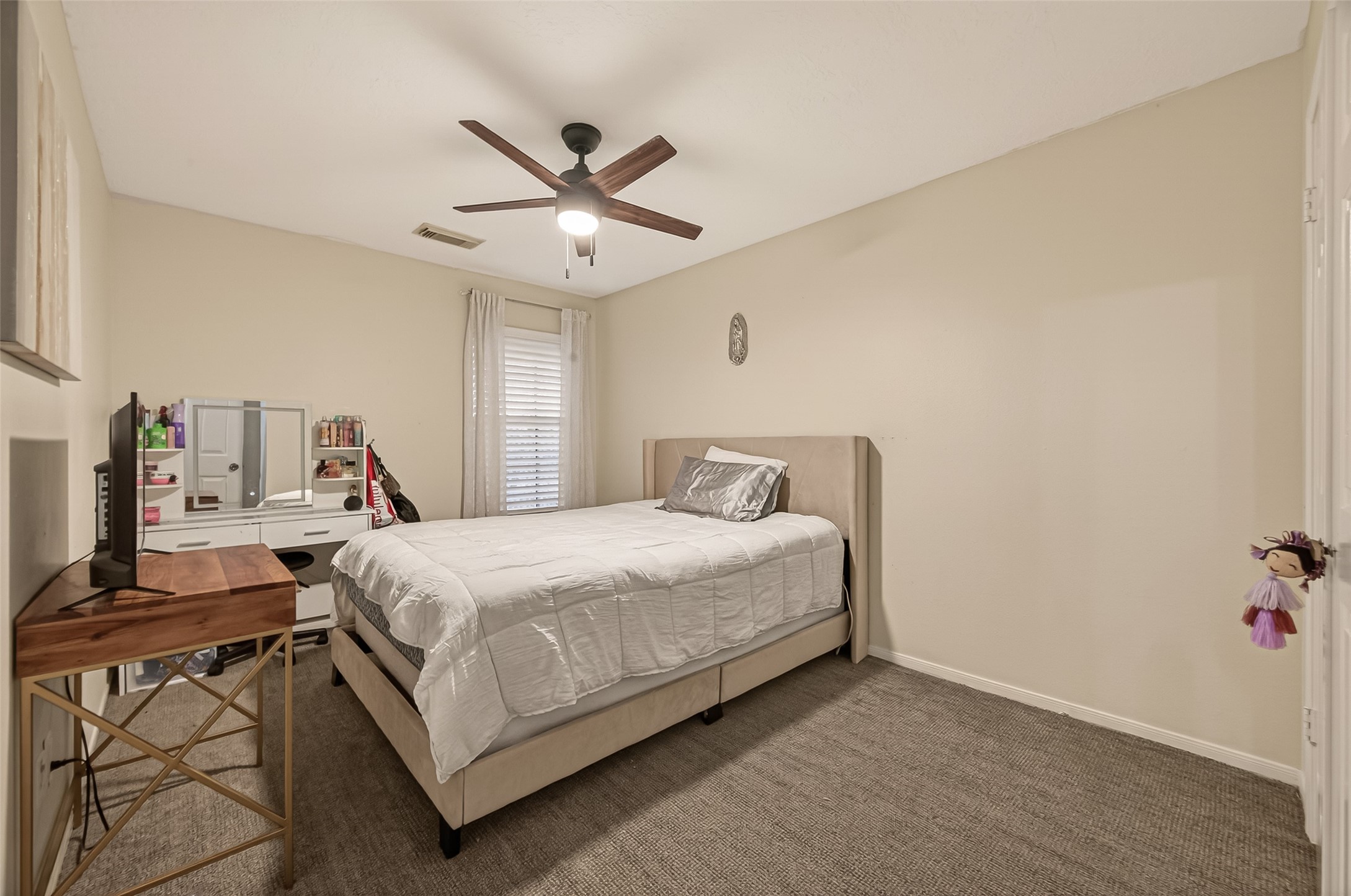 12206 Paddock Way Houston, TX 77065 - Photo 25 of 44 a bedroom with a bed and a chandelier